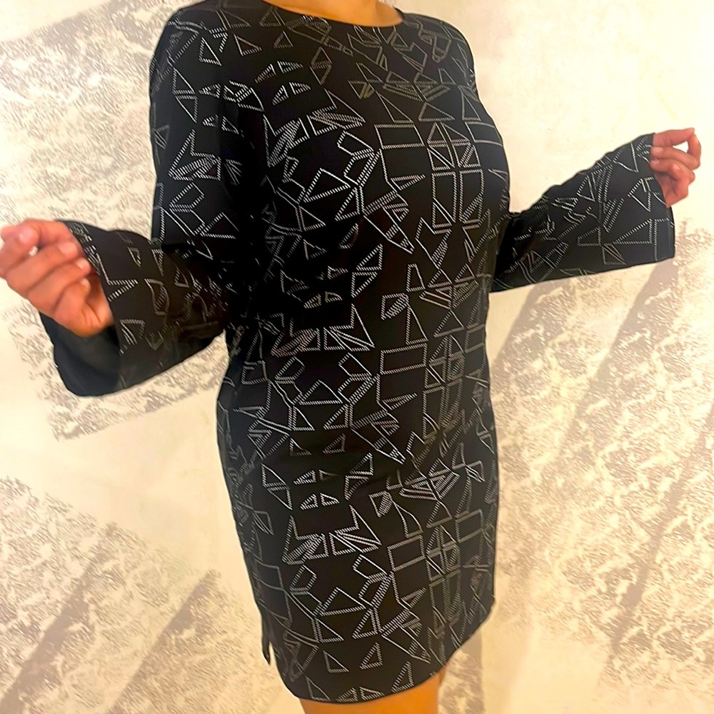 15% OFF HOLIDAYS black dress with silver . Slight opening in the back.